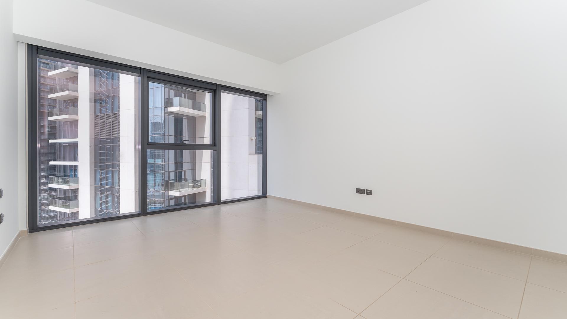 Modern open-plan living area in Act Towers apartment, Downtown Dubai, available for rent