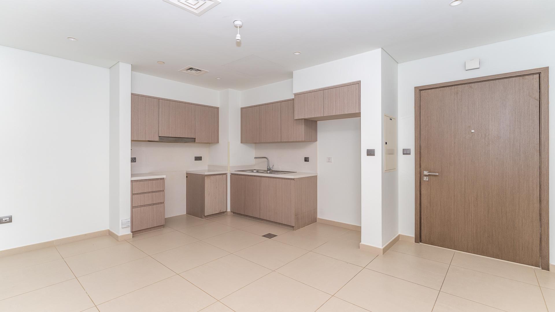 Empty room with large windows in Act Towers apartment, Downtown Dubai