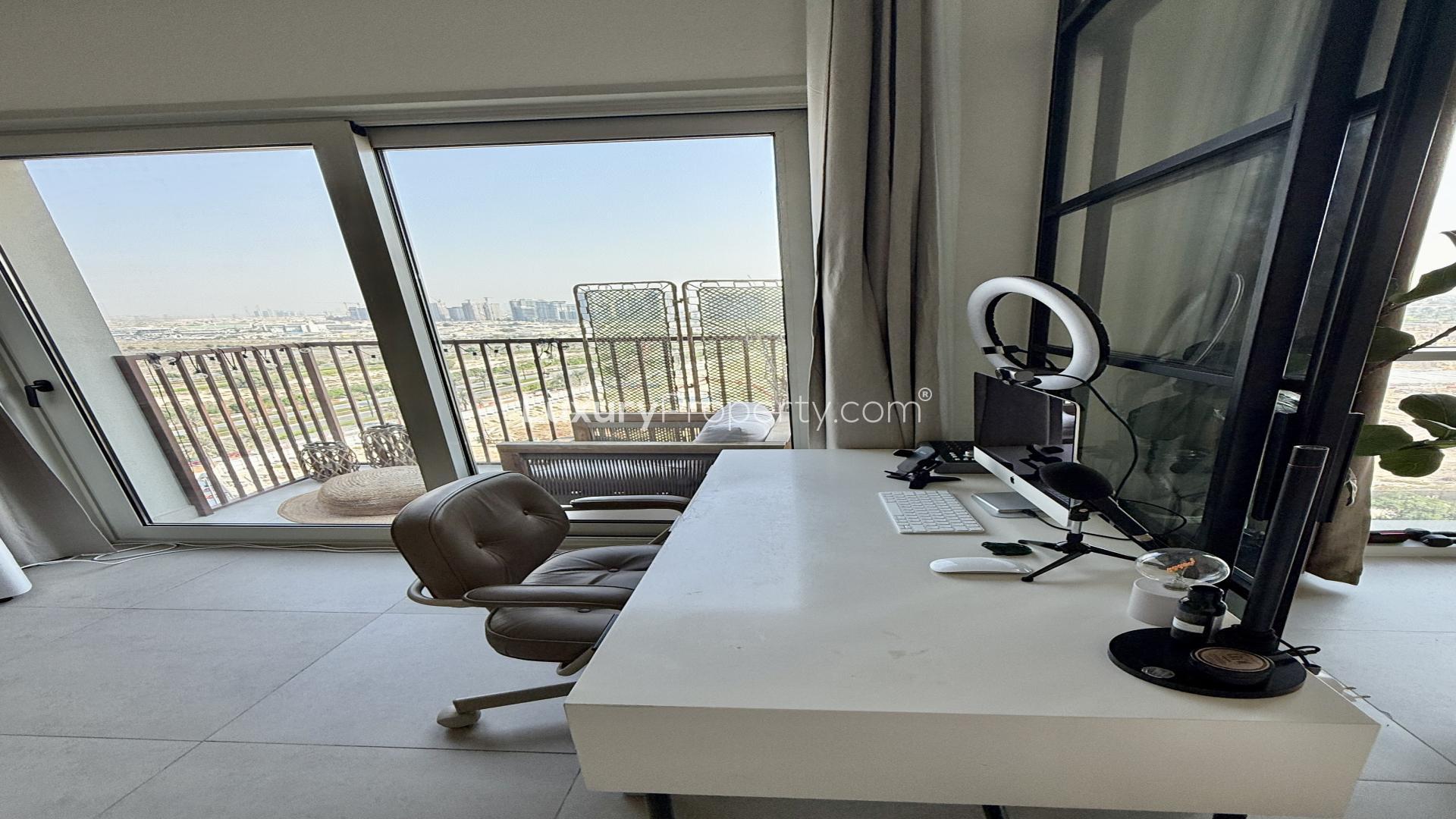 Modern living area in Dubai Hills Estate apartment, featuring sleek kitchen and stylish decor