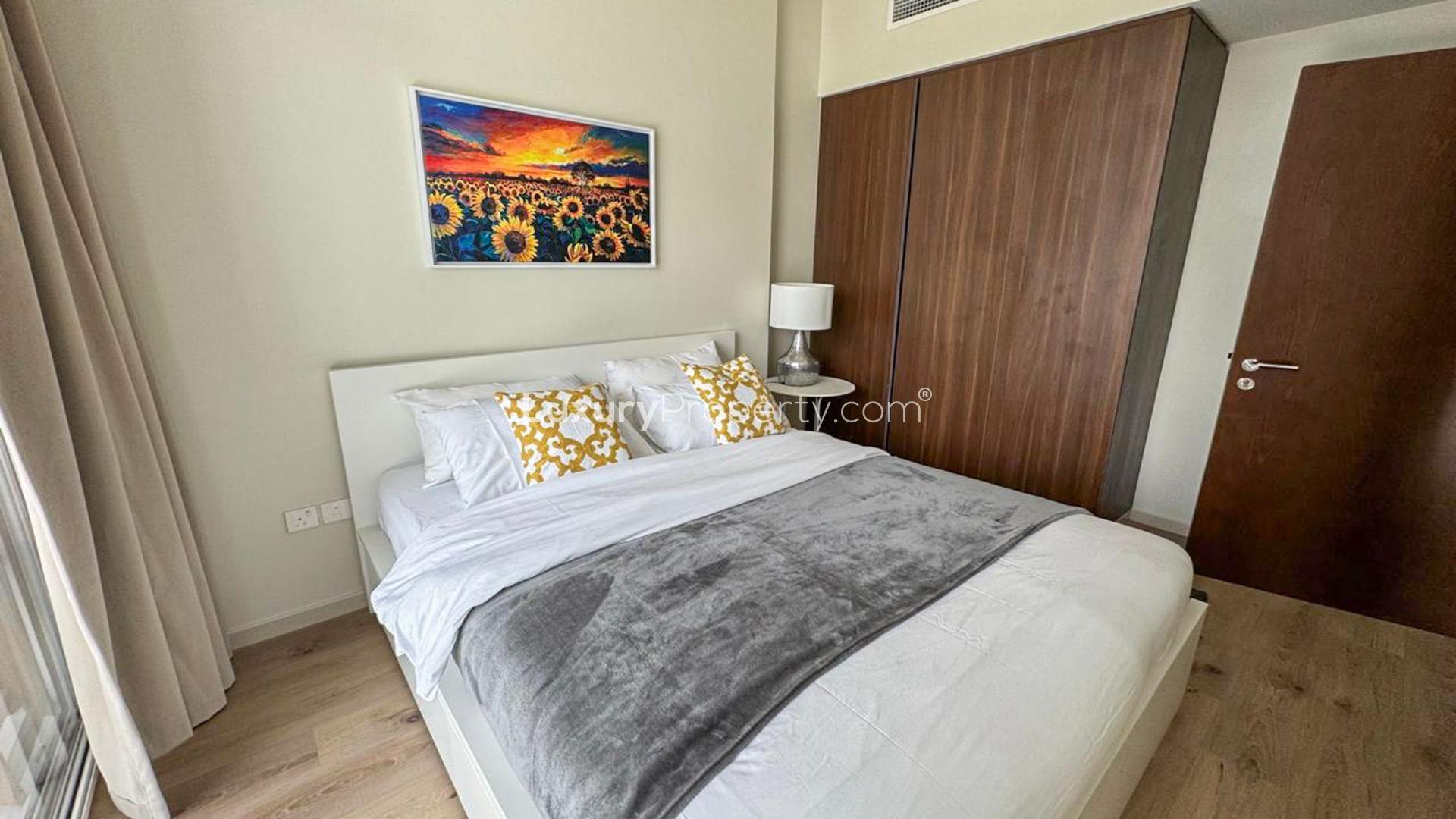 "Modern Binghatti Skyrise apartment living room with canal view in Business Bay, Dubai.",Modern bedroom in Binghatti Skyrise apartment, Business Bay, with stylish decor and wooden wardrobe