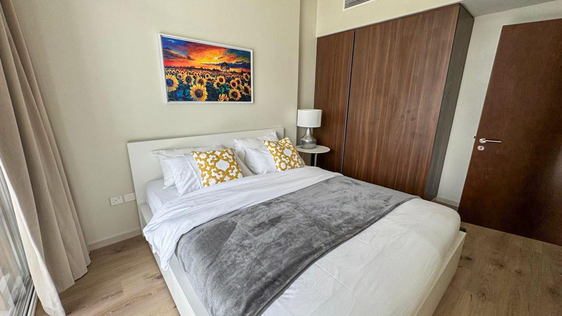 "Modern Binghatti Skyrise apartment living room with canal view in Business Bay, Dubai.",Modern bedroom in Binghatti Skyrise apartment, Business Bay, with stylish decor and wooden wardrobe