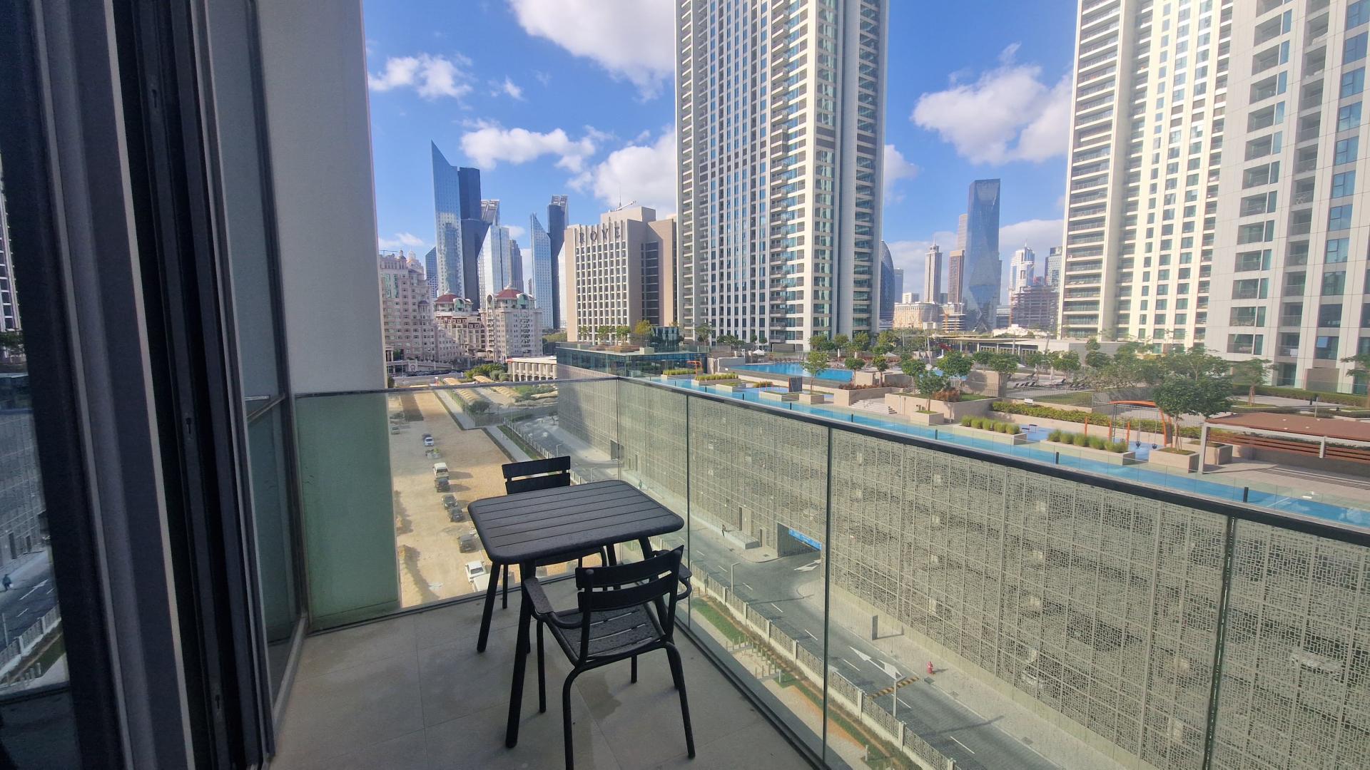 Modern living room in Downtown Views apartment with large windows and stylish furniture, LP47813