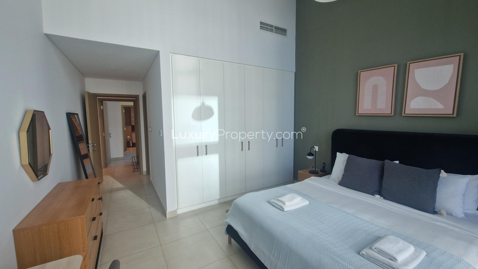 Modern downtown apartment bedroom with large window and city view, available for rent