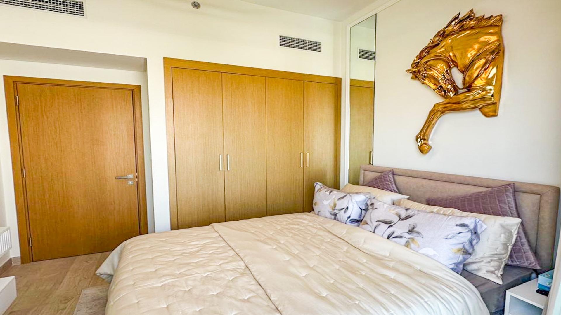 Modern bedroom with balcony, stylish lighting, and decor in Fawad Azizi Residence, Al Jaddaf