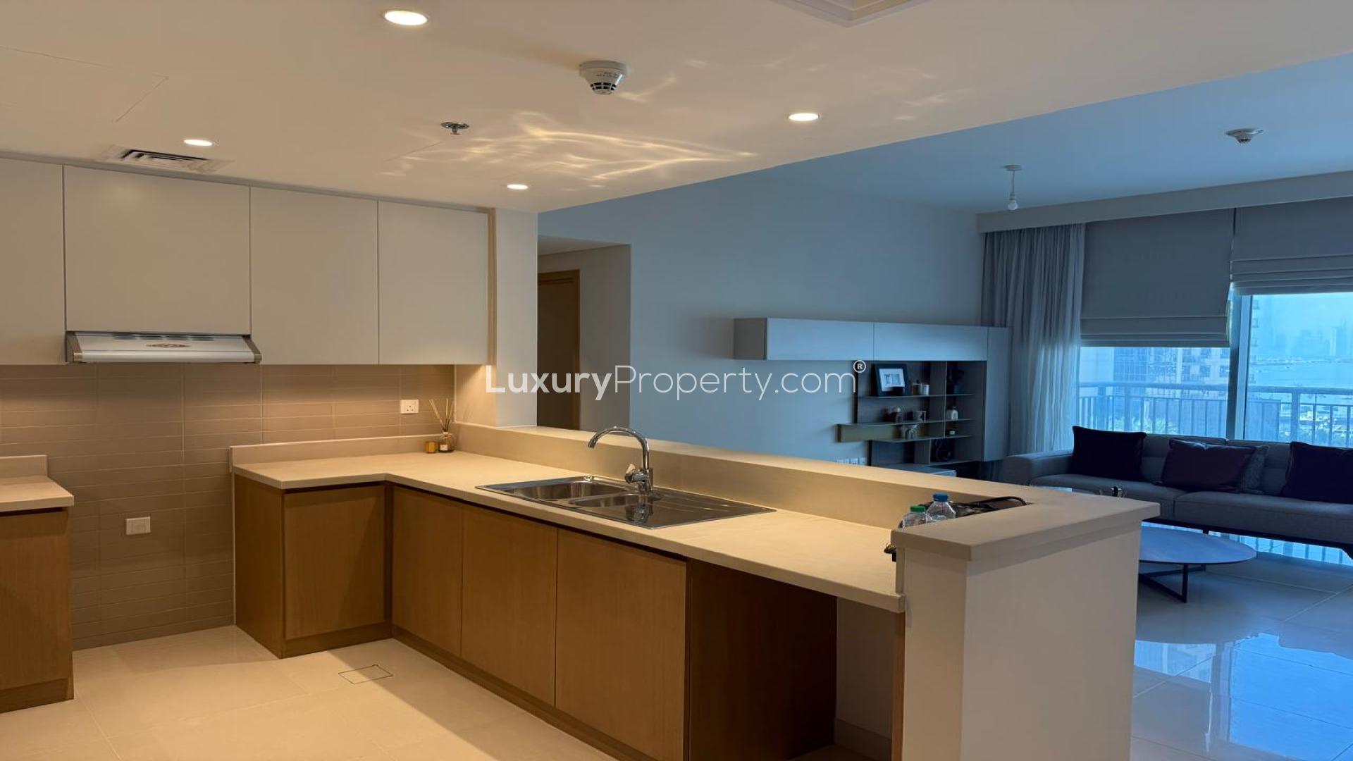 Unfurnished living room in Dubai Creek Harbour apartment with modern decor and open kitchen
