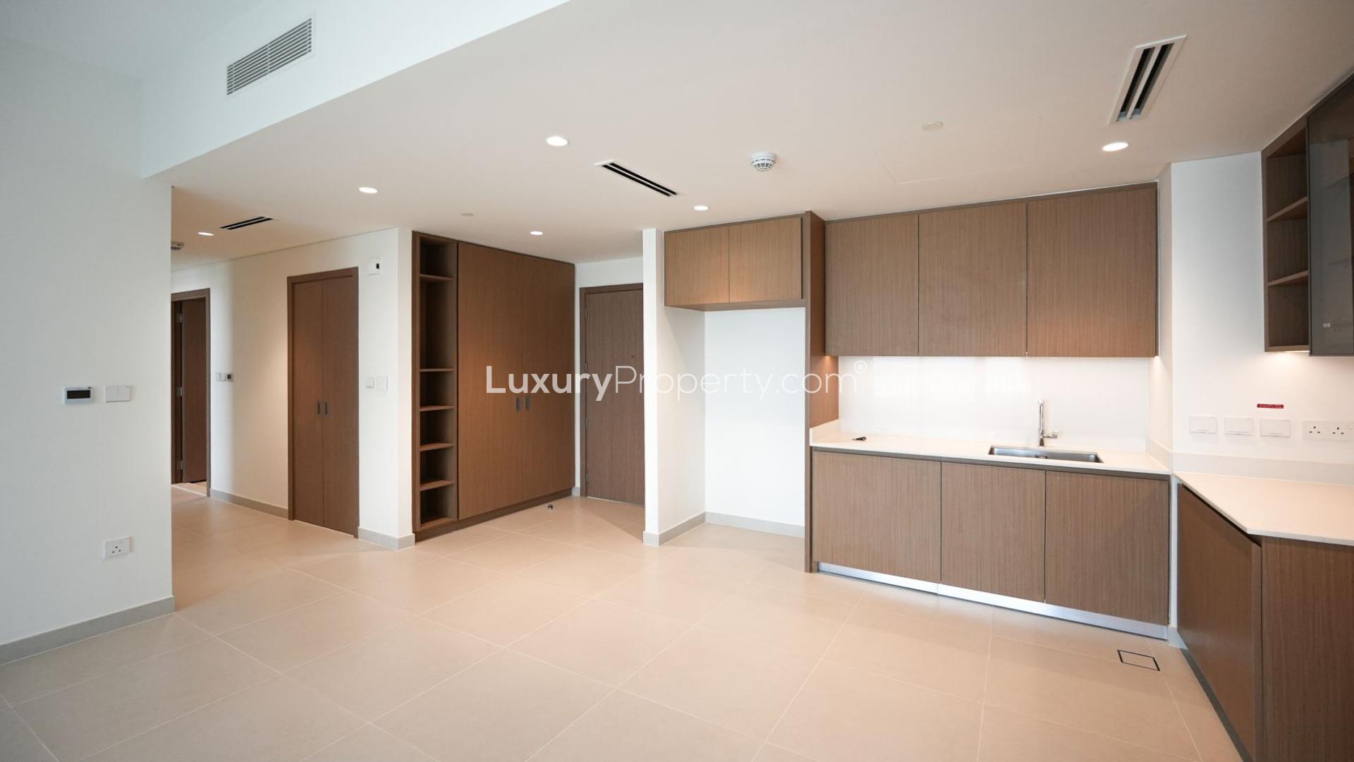 Modern living room in Creek Beach Savanna apartment, Dubai Creek Harbour, with balcony view