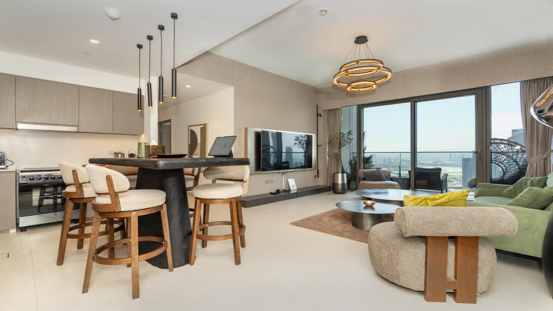 Modern living room in Grande Signature Residences apartment, Downtown Dubai, with city skyline view