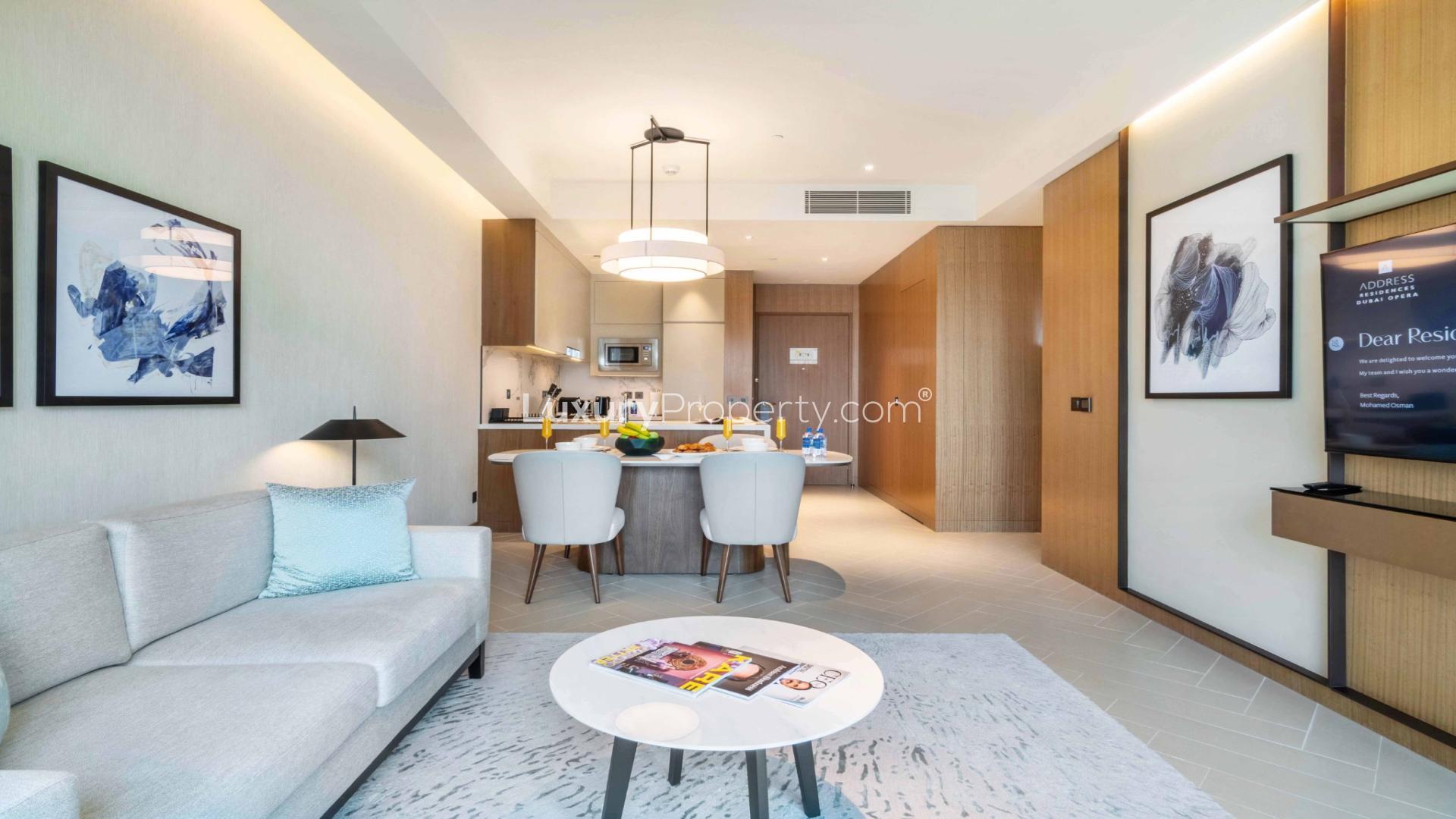 "Modern living room with dining area, stunning Downtown Dubai views, Address Residences Opera Tower apartment.",Modern living room and kitchen in Downtown Dubai apartment for rent, Address Residences Opera