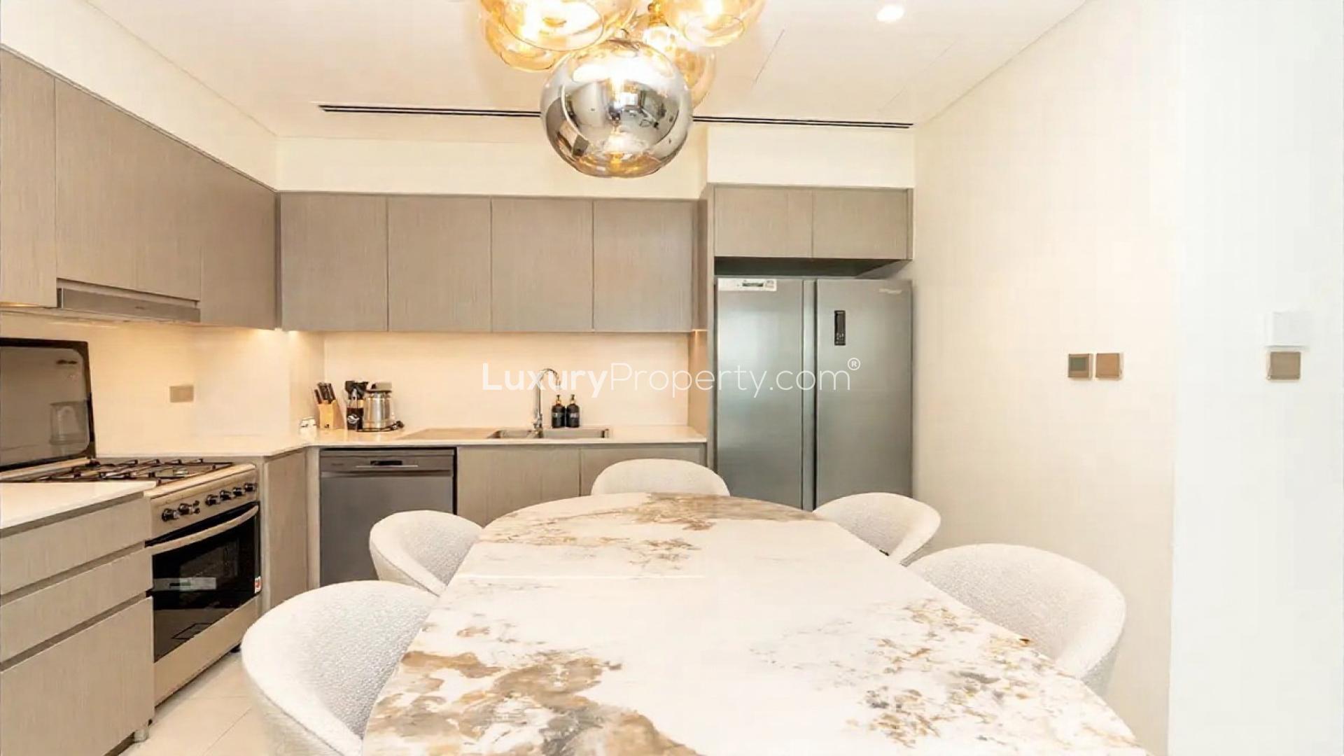 "Luxury apartment balcony with peaceful view in Opera District, Grande community.",Luxurious kitchen in Grande apartment, Opera District, with modern design and elegant dining area