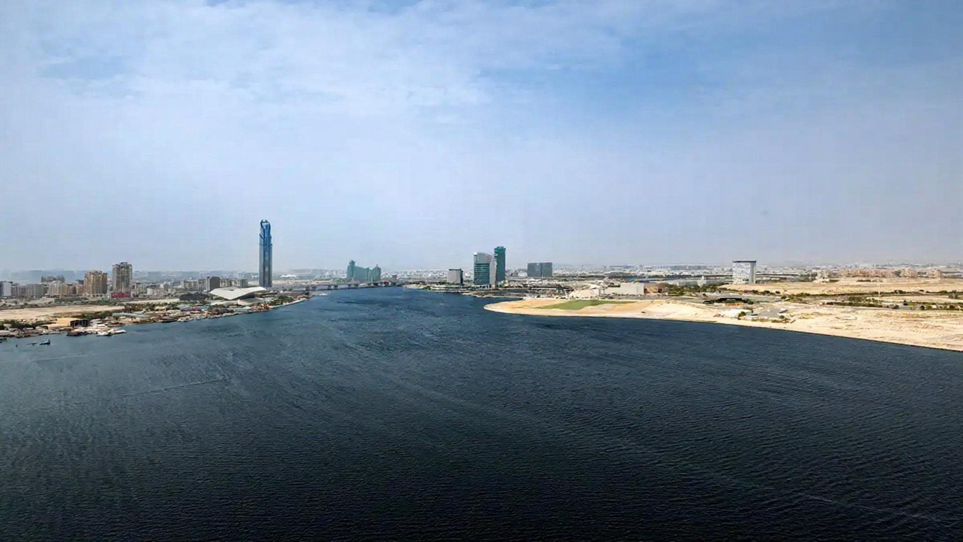 Open-plan kitchen and living area in Dubai Creek Harbour apartment for rent