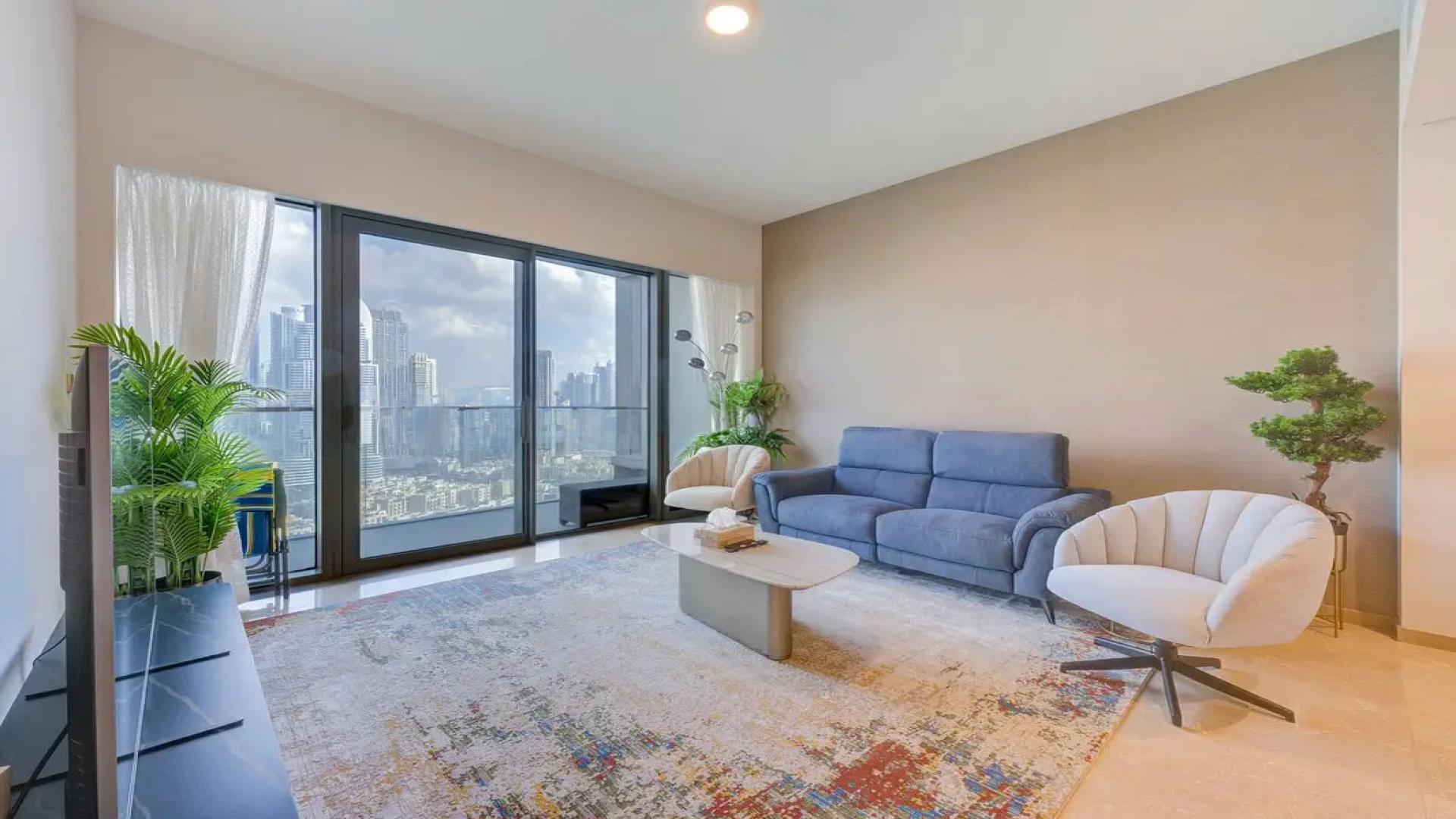 Modern living room in Dubai Creek Harbour apartment with city view, stylish furniture, and decor