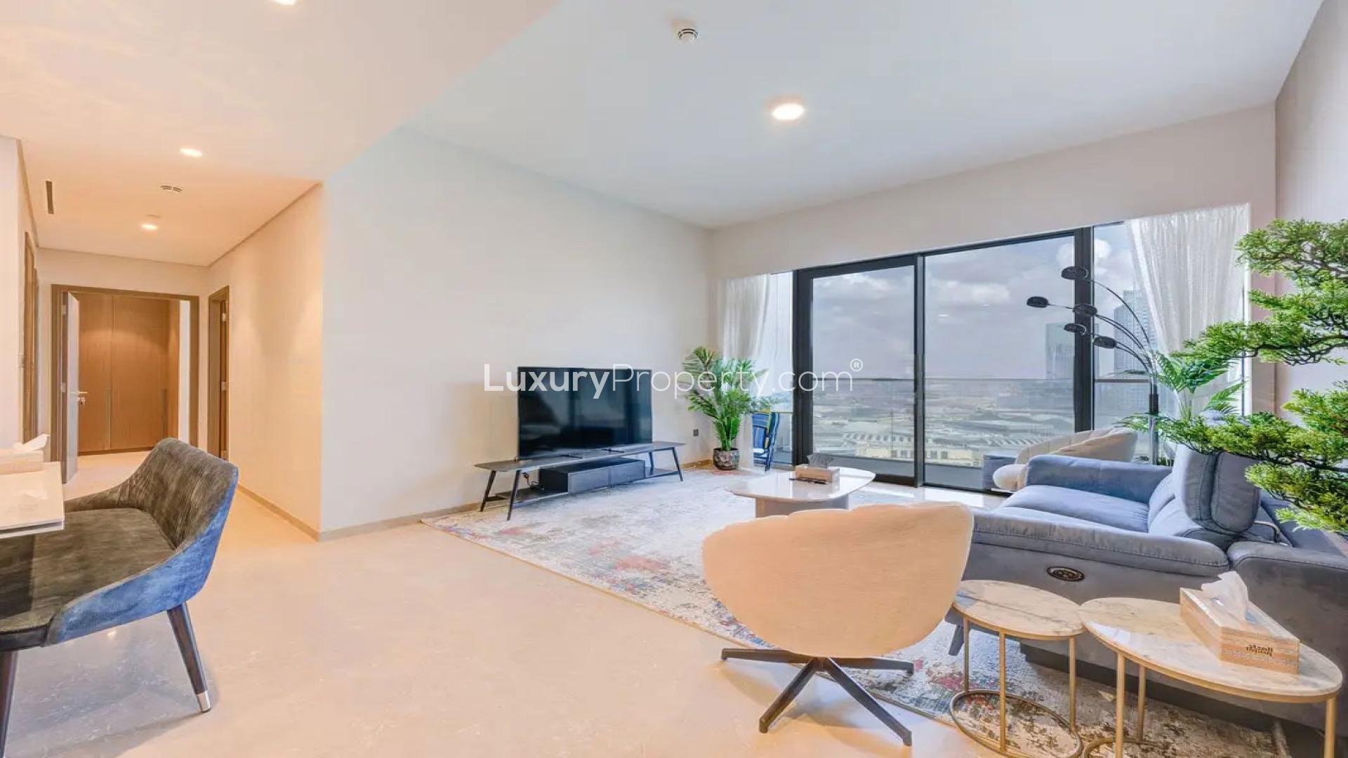 Modern living room in Dubai Creek Harbour apartment, featuring sleek decor and large windows