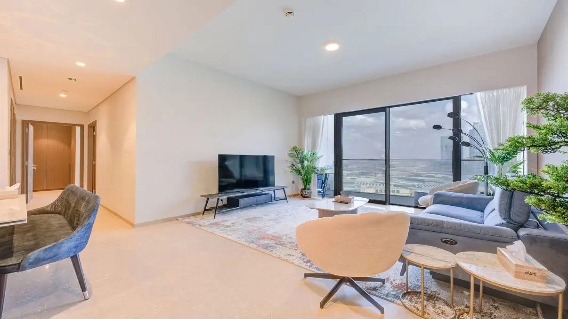 Modern living room in Dubai Creek Harbour apartment, featuring sleek decor and large windows