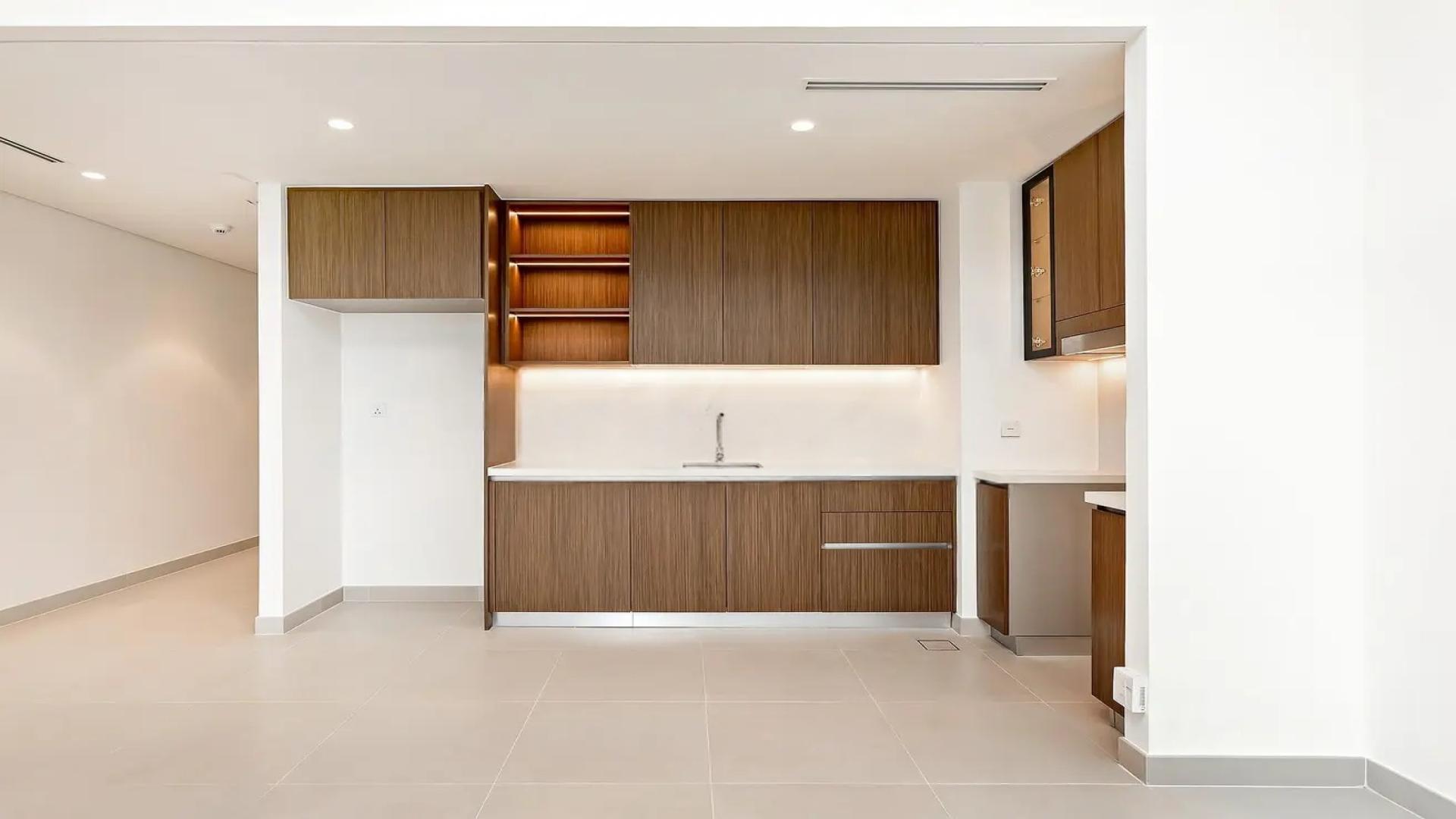 Modern open-plan kitchen and living area in Dubai Creek Harbour apartment for rent