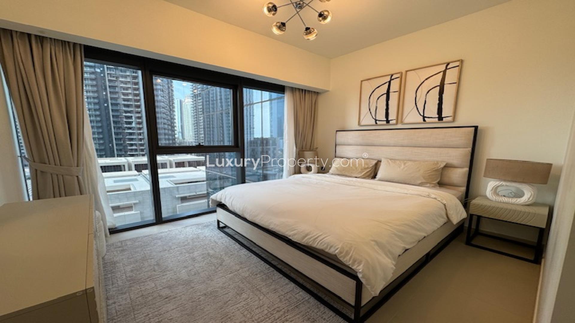 Modern bedroom in Downtown apartment, featuring large window with city view, Act Towers