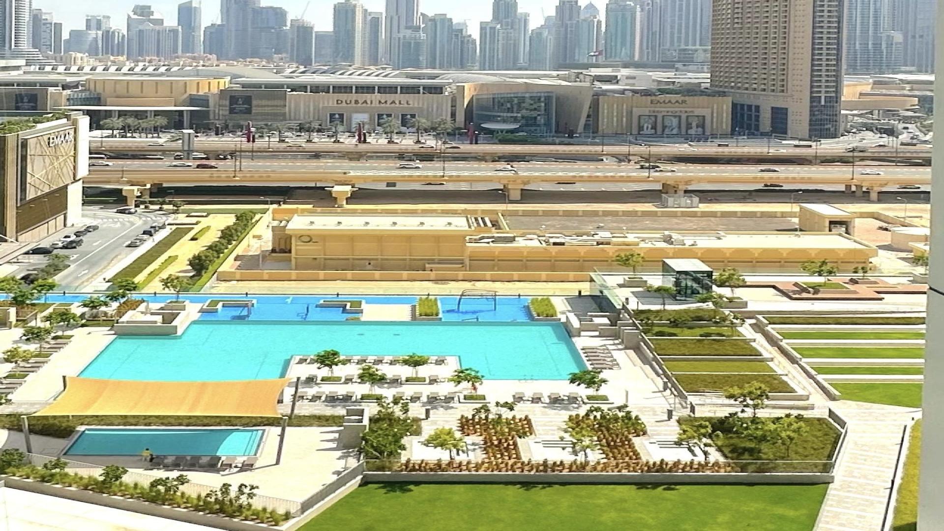Modern living room in Downtown Dubai apartment, featuring elegant furnishings and large windows