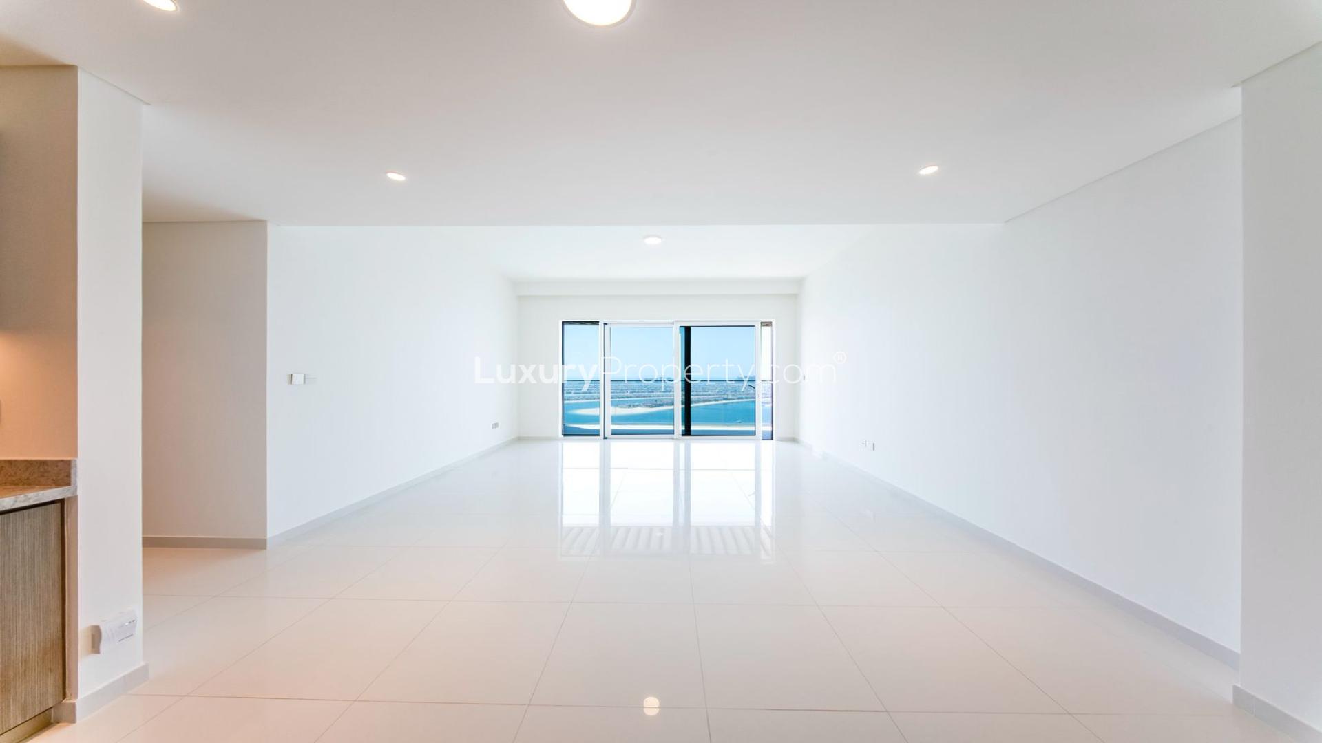 Modern kitchen with open living space and Palm view at Emaar Beachfront apartment