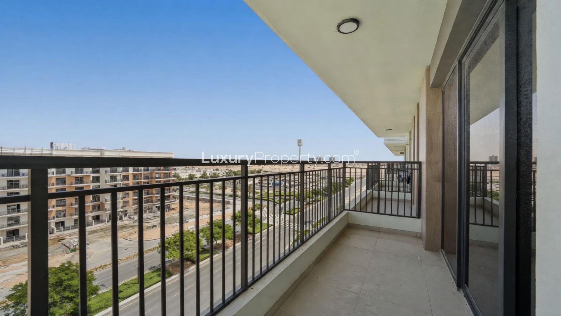 Bright living room with wooden floors and balcony view in Holland Gardens, Town Square apartment