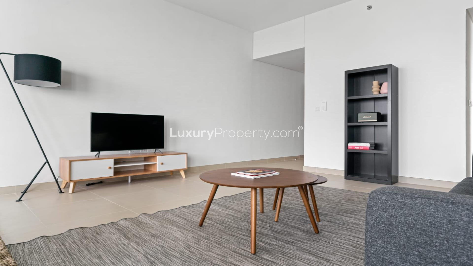 Modern dining area in Dubai Marina apartment, featuring large windows and balcony view
