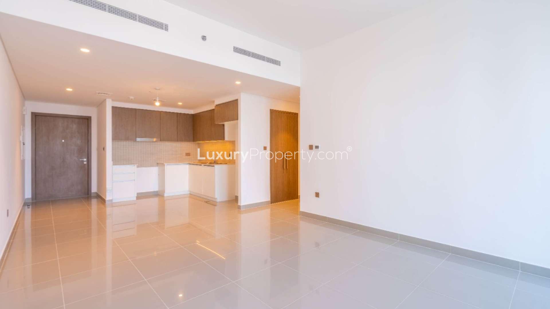 "View from 2-bedroom apartment balcony in 17 Icon Bay, Dubai Creek Harbour, overlooking cityscape.",Bright living room with balcony view in 2-bedroom apartment, 17 Icon Bay, Dubai Creek Harbour