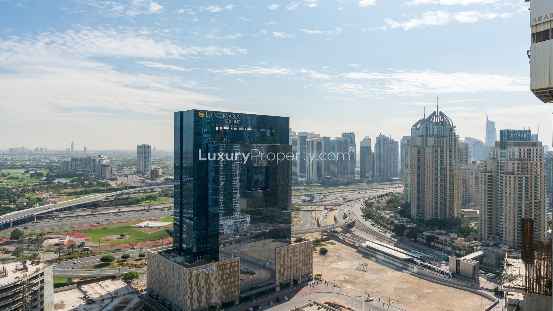 Open-plan living area with large windows in 2-bedroom Dubai Marina apartment for rent