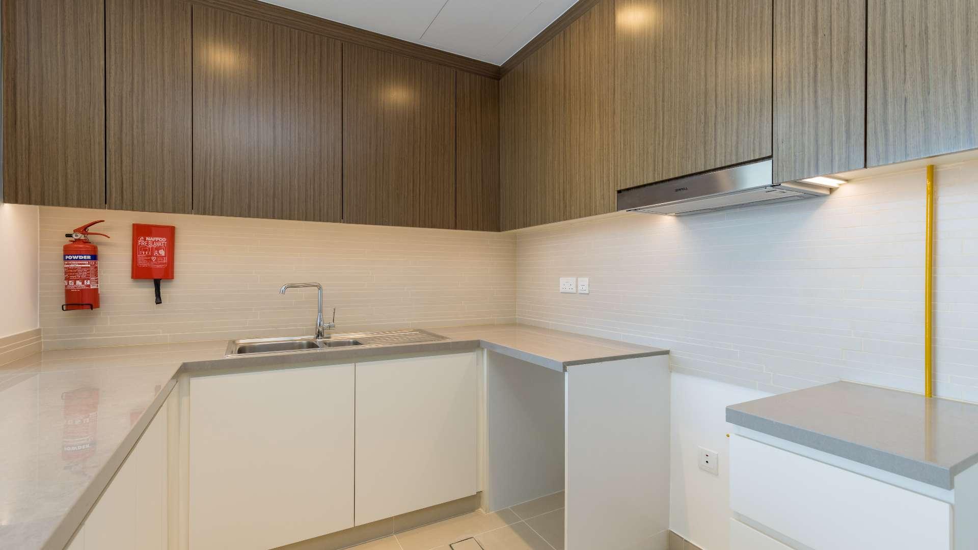 Modern kitchen in brand new 2-bedroom Dubai Marina apartment, featuring sleek cabinetry and countertops