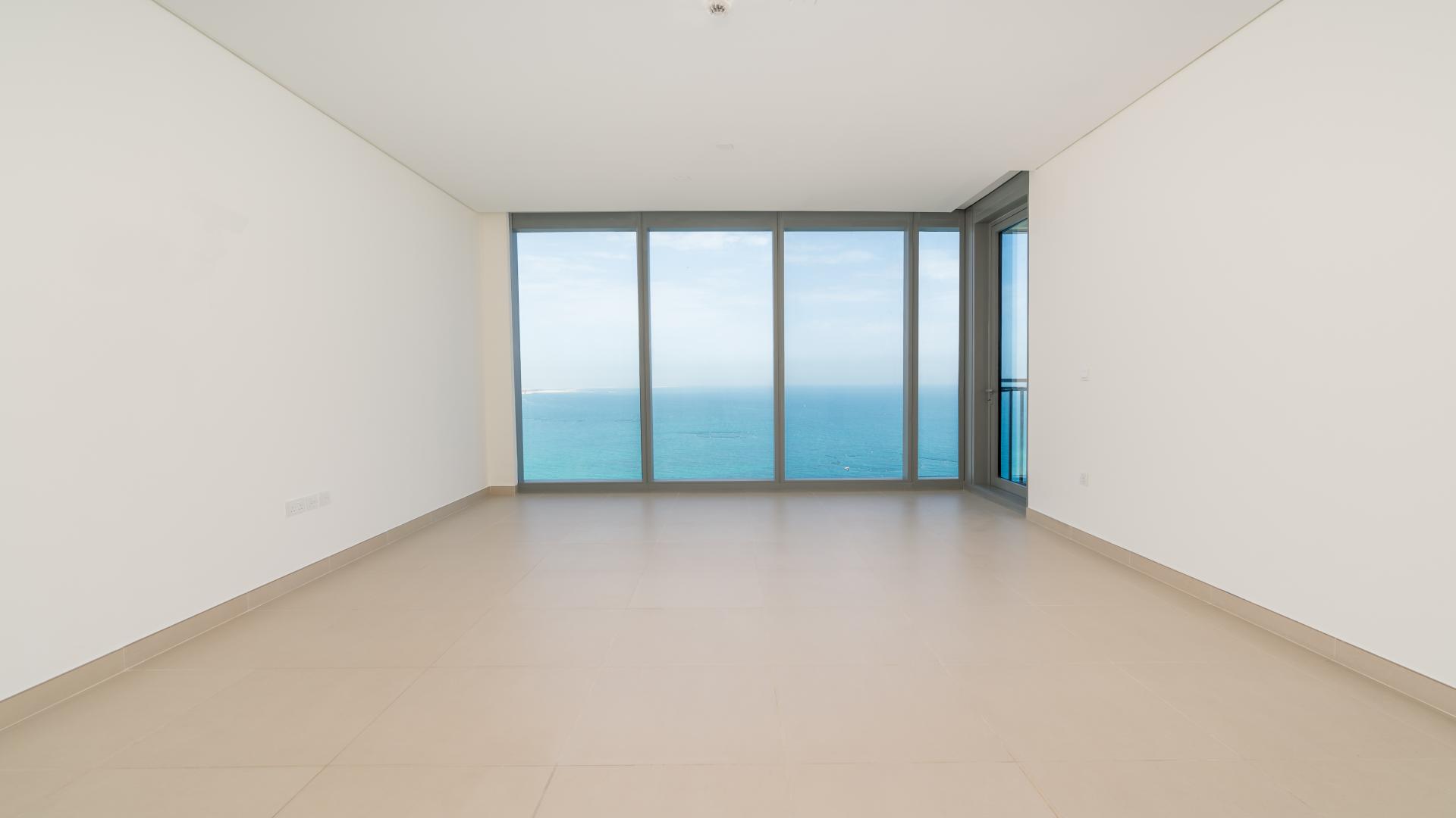 "Stunning sea view from luxury apartment balcony in 5242 Tower, Dubai Marina.",Empty luxury apartment living room with ocean view in 5242 Tower 1, Dubai Marina