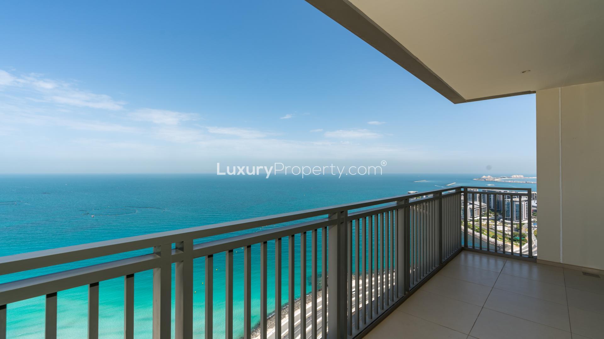 "Stunning sea view from luxury apartment balcony in 5242 Tower 1, Dubai Marina.",Luxurious Dubai Marina apartment with sea view, spacious living area, and modern design