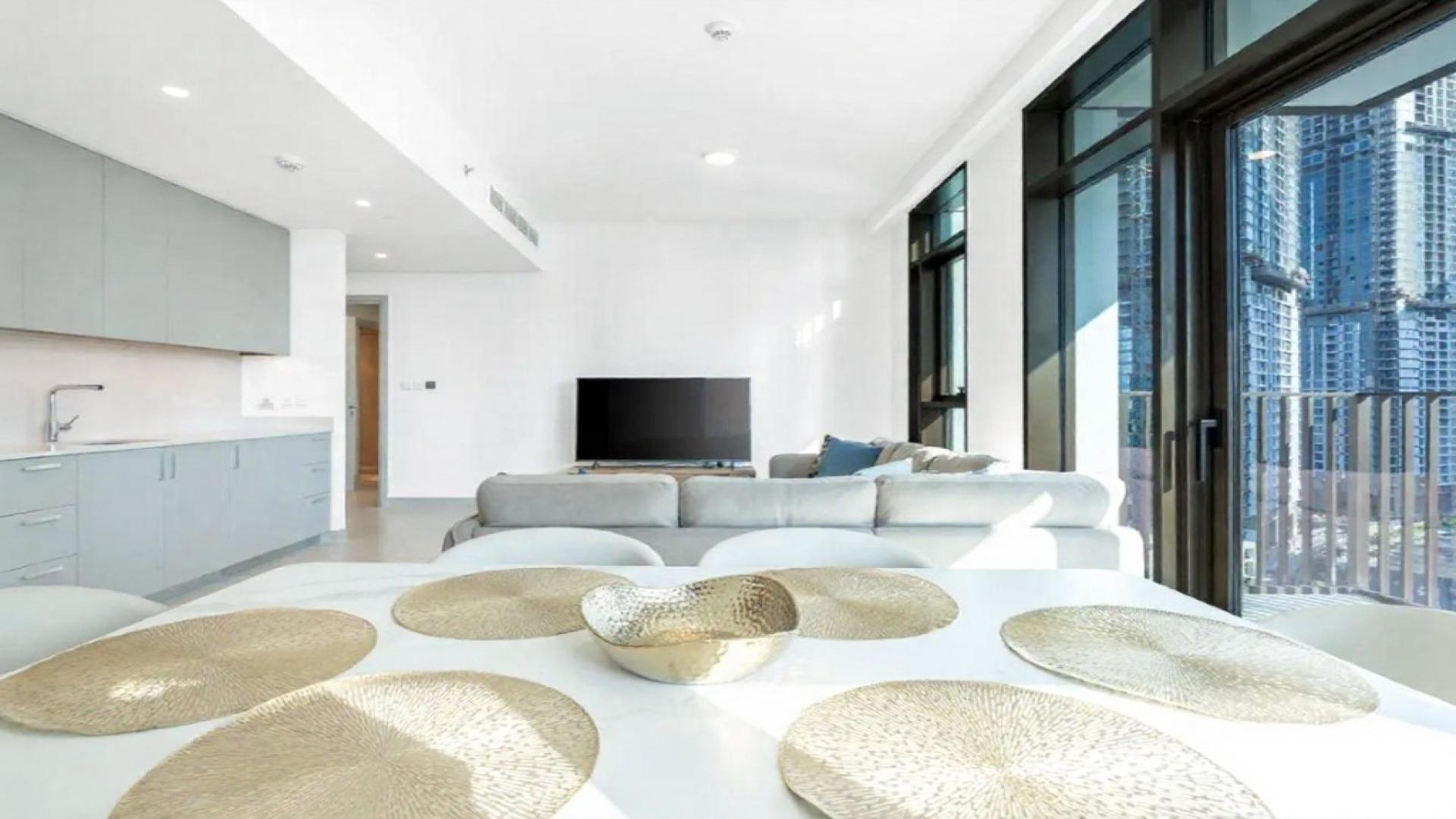 "Spacious living room with city views in Creek Crescent, Dubai Creek Harbour apartment.",Modern living room in fully furnished Dubai Creek Harbour apartment with city view