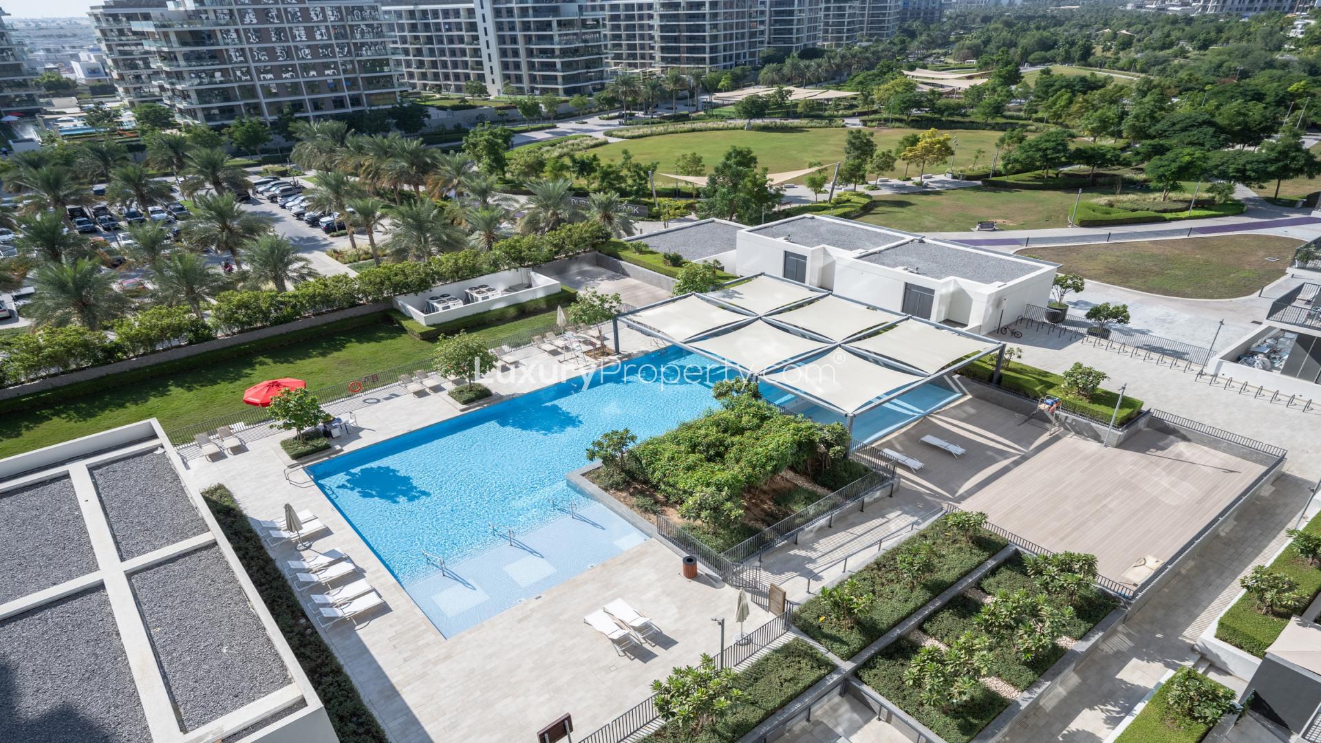 Balcony view from 2-bedroom apartment in Park Ridge Dubai Hills, overlooking pool and gardens