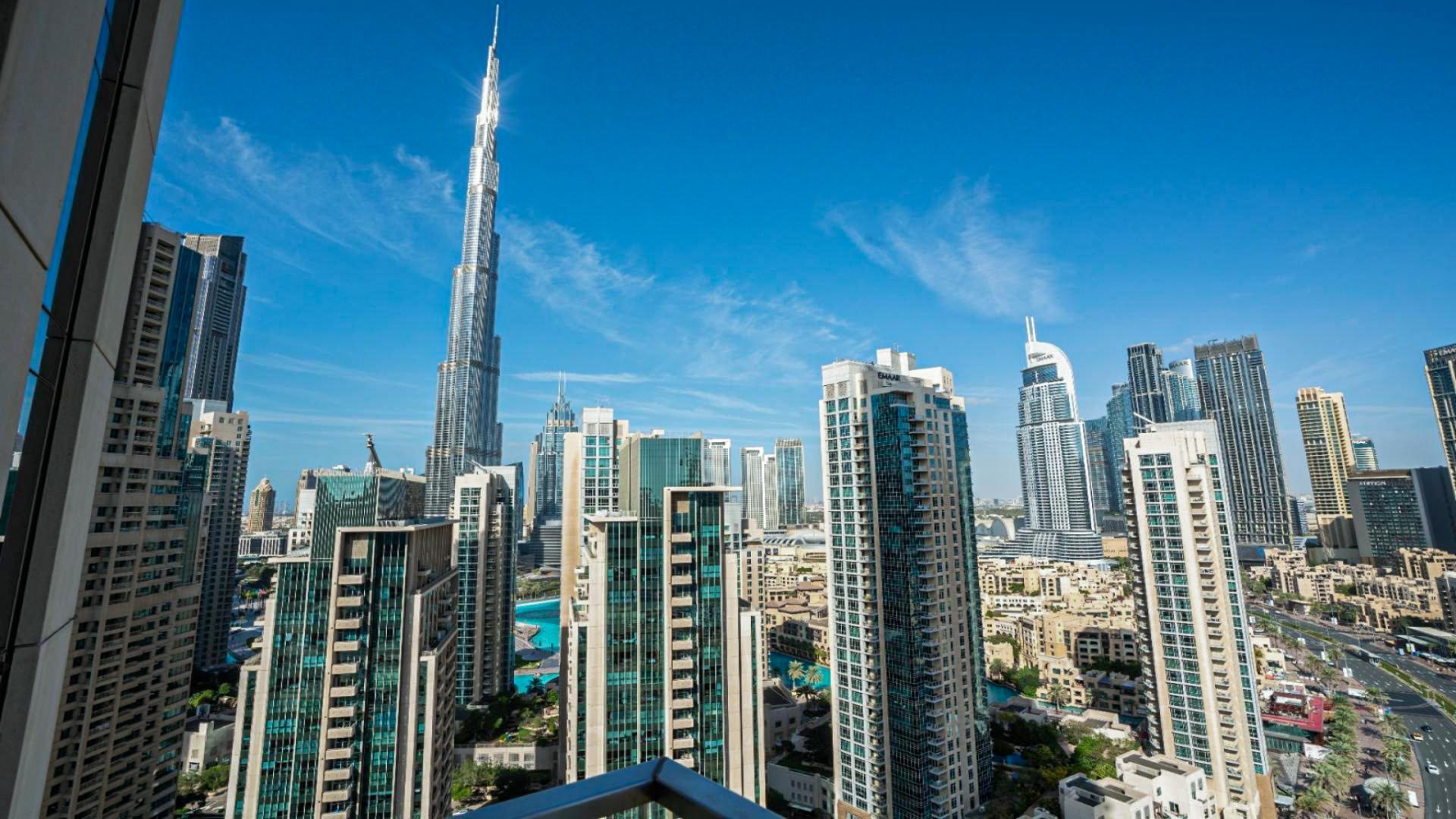 Fully furnished open-plan kitchen and living area in Vida Residence Downtown apartment