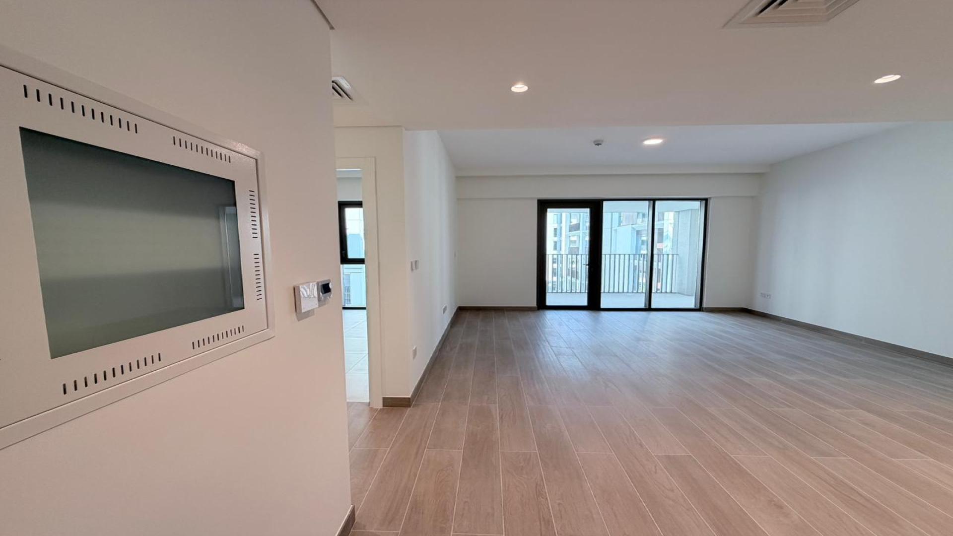 Empty living area in Dubai Creek Harbour apartment for rent, featuring modern design and flooring