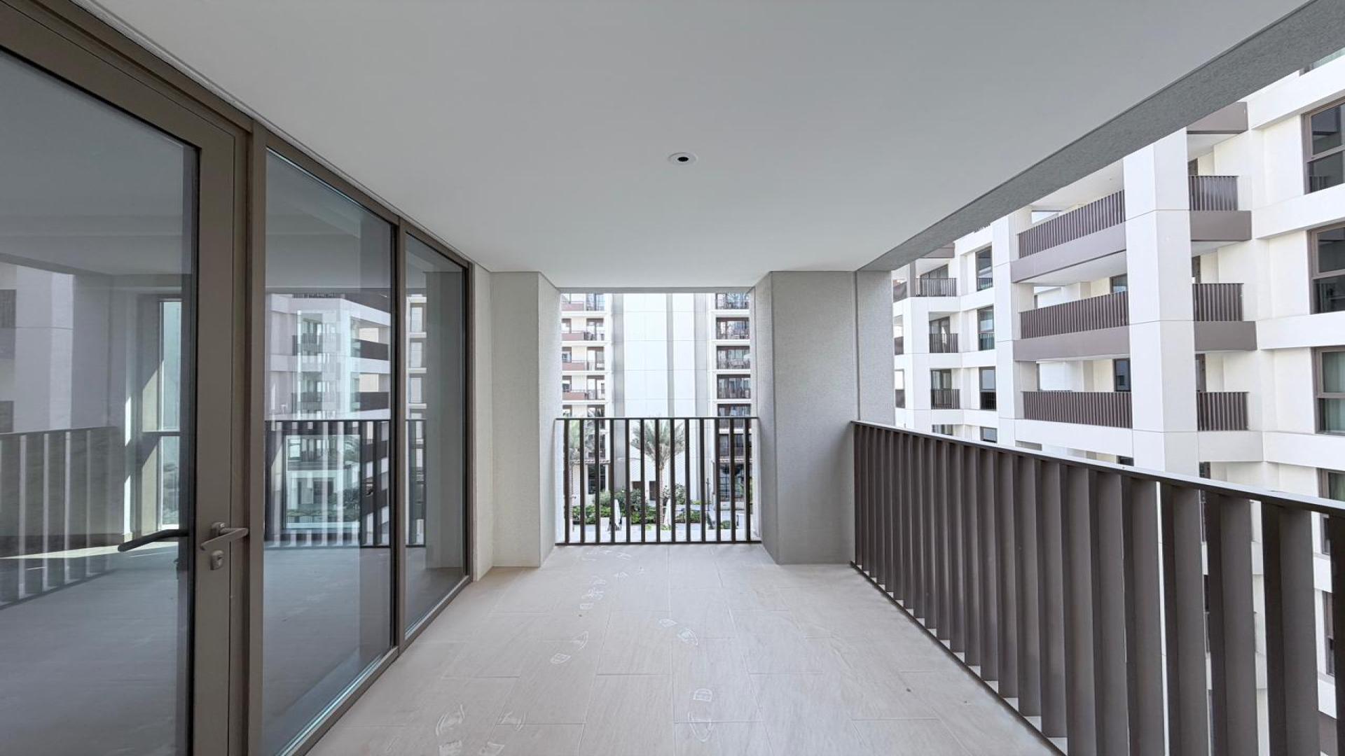 Modern kitchen and living area in Dubai Creek Harbour apartment for rent