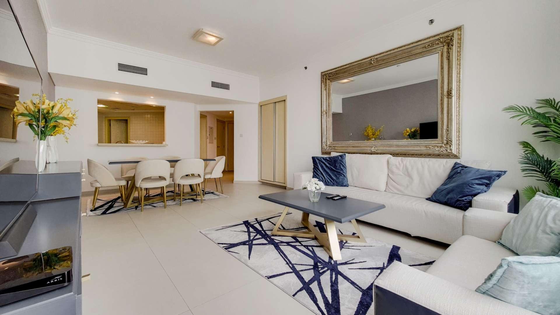 Modern furnished living and dining area in Al Bateen Residence apartment with marina views