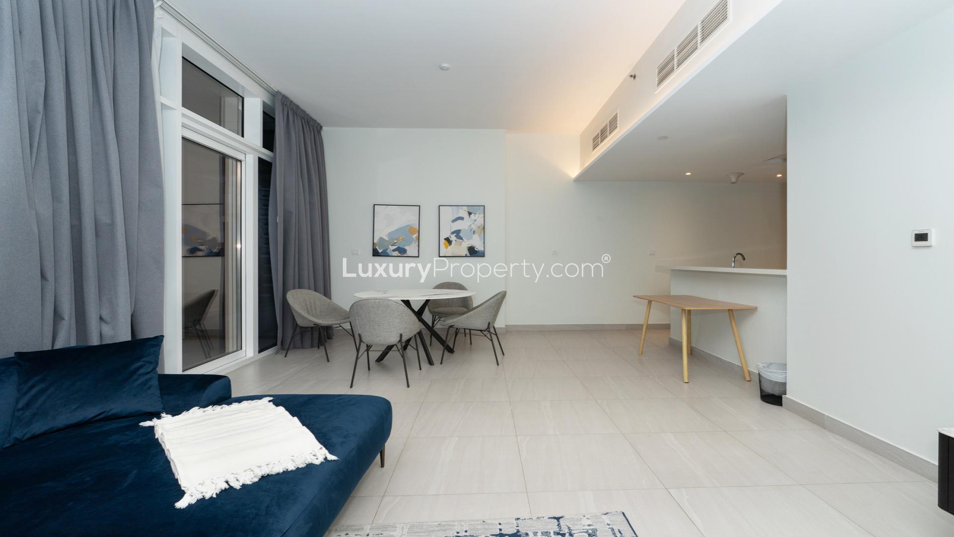 Modern living room in Park Gate Residences apartment, Al Kifaf, with blue sofa and TV