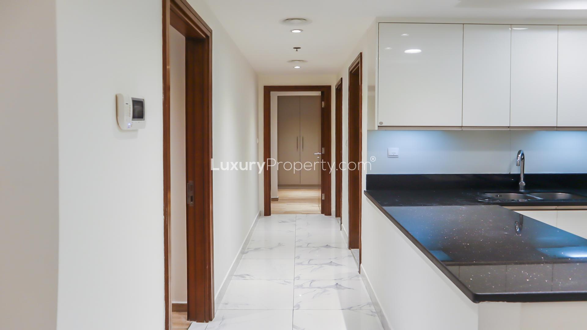 Modern kitchen and living area in Al Habtoor City apartment, Business Bay for rent