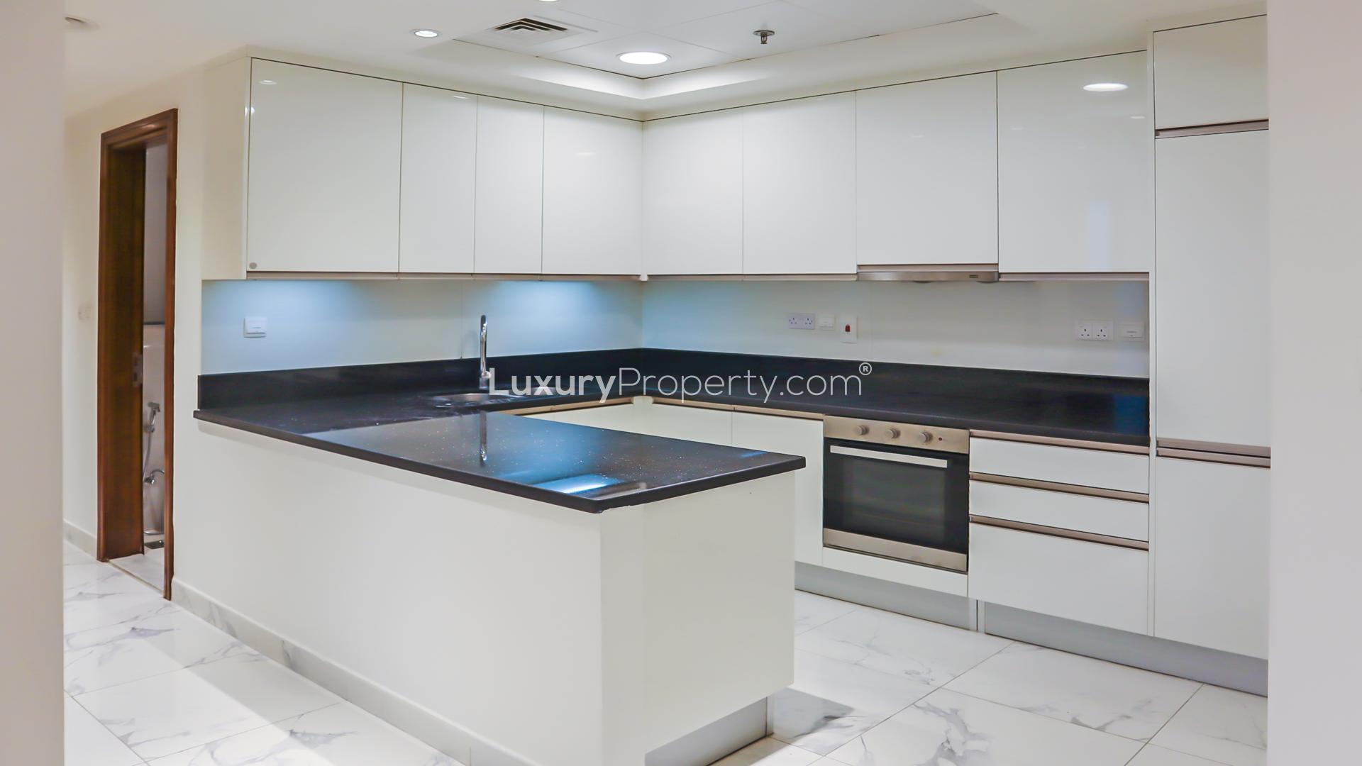 Empty room with large windows, marble floor in Business Bay apartment, Al Habtoor City