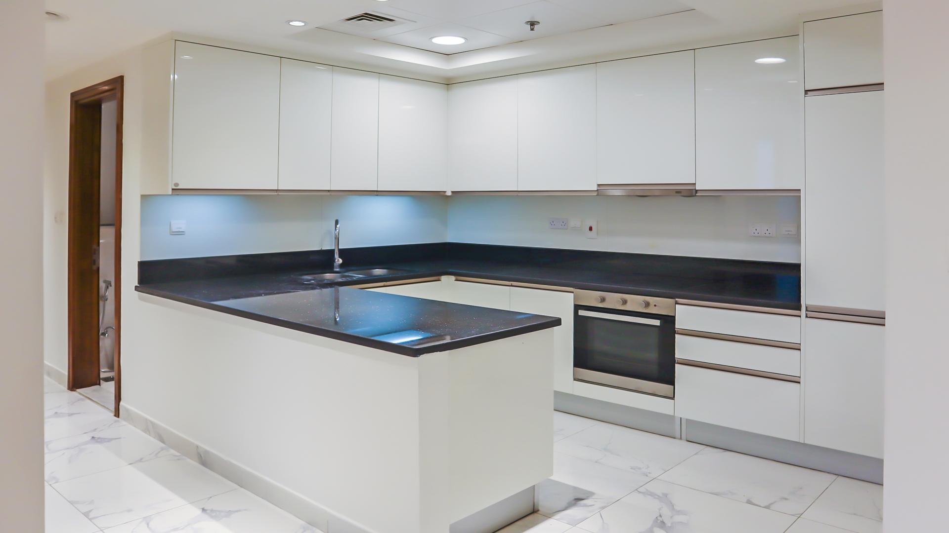Empty room with large windows, marble floor in Business Bay apartment, Al Habtoor City