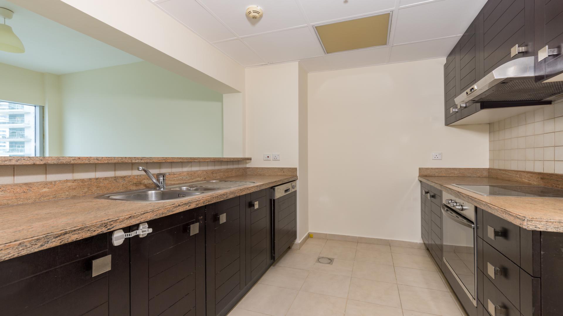 Spacious living room in Al Habtoor City apartment, Business Bay, with open kitchen layout