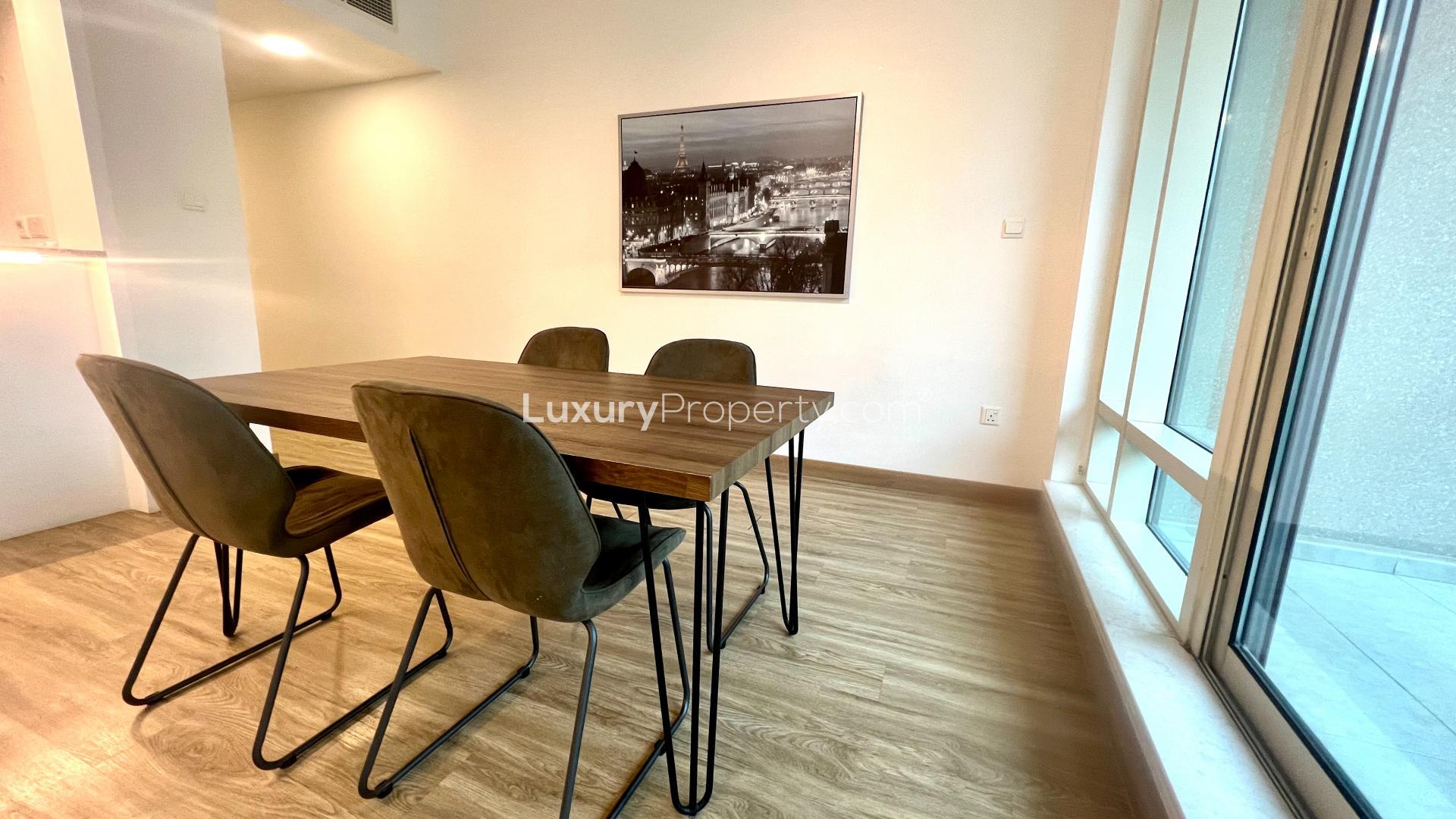 Modern Dubai Marina apartment view with high-rise buildings and waterfront in Al Majara community