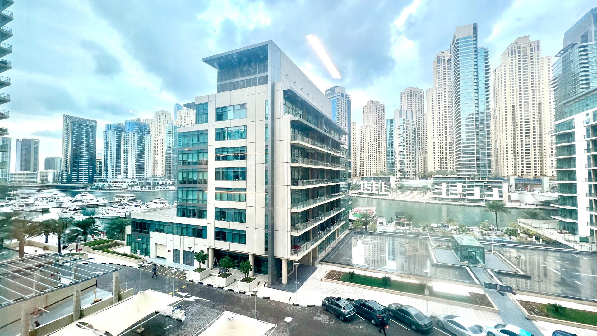 Dining area with modern table and chairs in Dubai Marina apartment, Al Majara