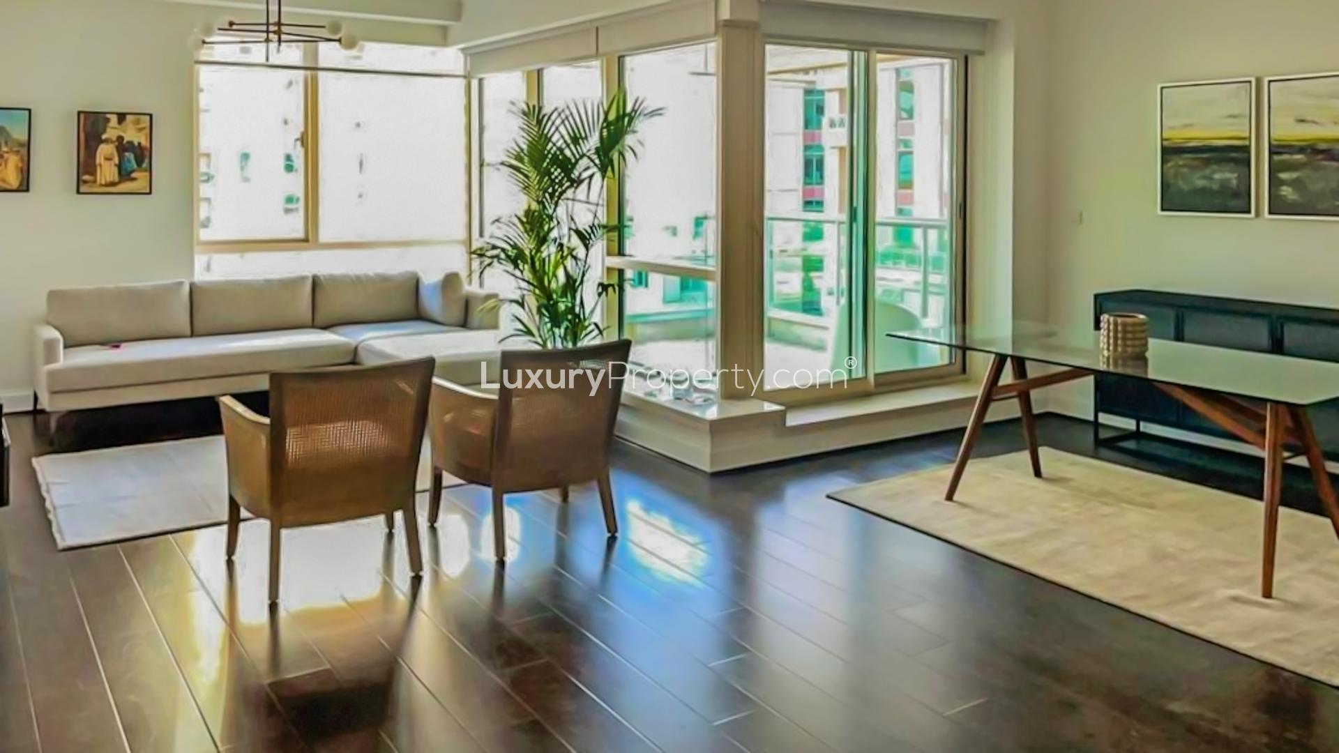 Furnished living room in Dubai Marina apartment, featuring modern decor and large windows