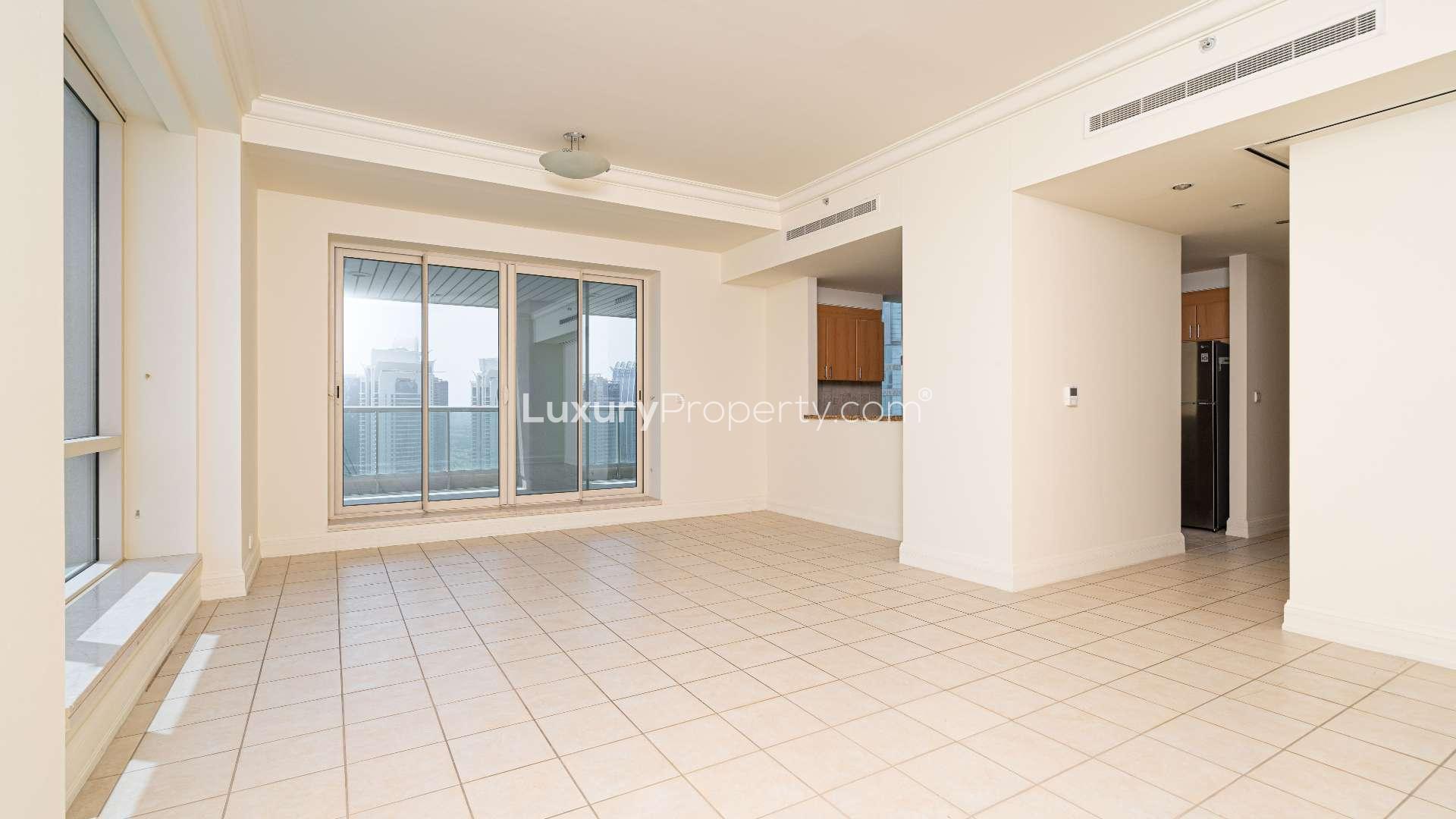 "Stunning view of Dubai Marina from Murjan Towers apartment in Emaar 6 Towers community.","Spacious living area in Murjan Towers two-bedroom apartment, Dubai Marina, with balcony view.","Spacious balcony view from two-bedroom apartment in Murjan Towers, Dubai Marina.",Open-plan kitchen and living area in Murjan Towers apartment, Dubai Marina, Emaar 6 Towers