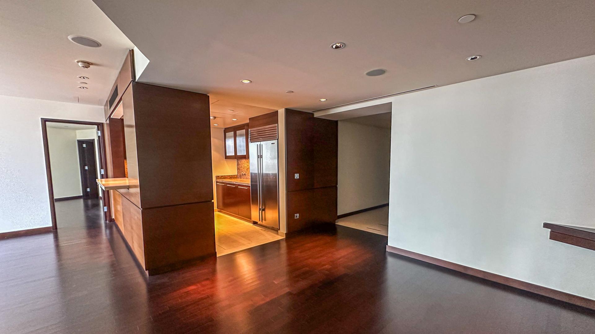 High-floor Burj Khalifa apartment interior with modern kitchen and expansive city views