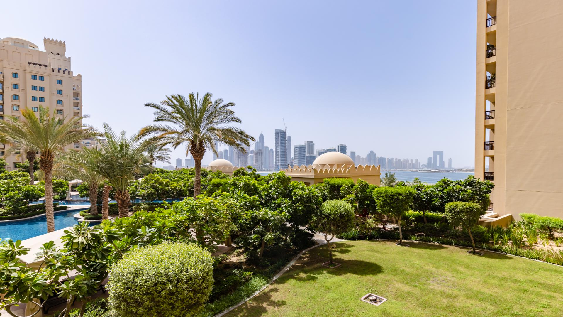 Luxurious living room in Palm Jumeirah apartment with stylish decor and garden views
