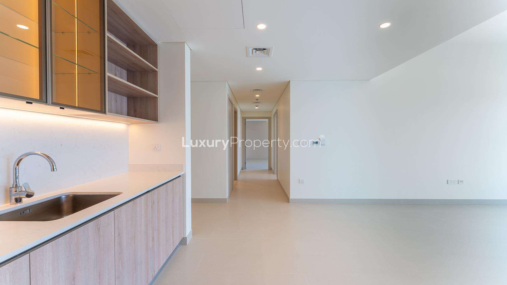 Modern kitchen in Dubai Hills Estate apartment for rent, featuring sleek cabinetry and lighting