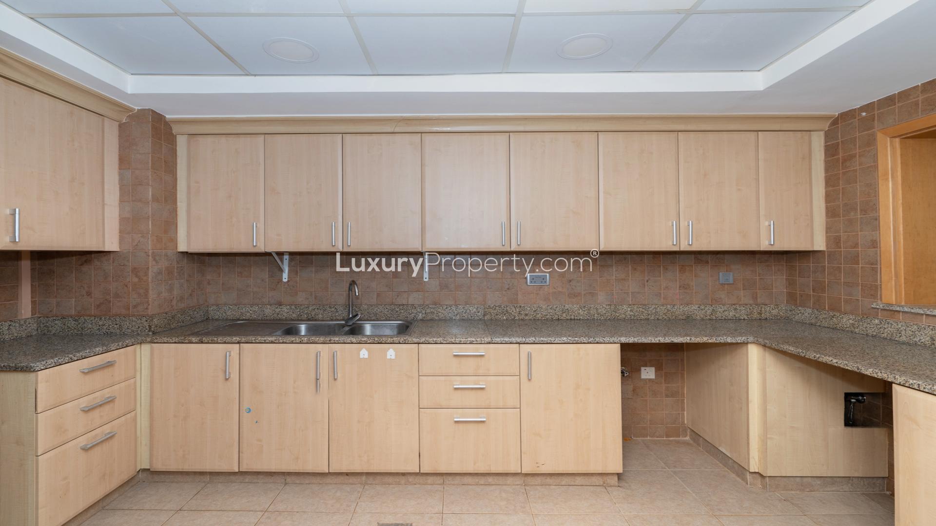 Spacious living area in Al Tamr Apartment, Palm Jumeirah, with modern lighting and tiled floors