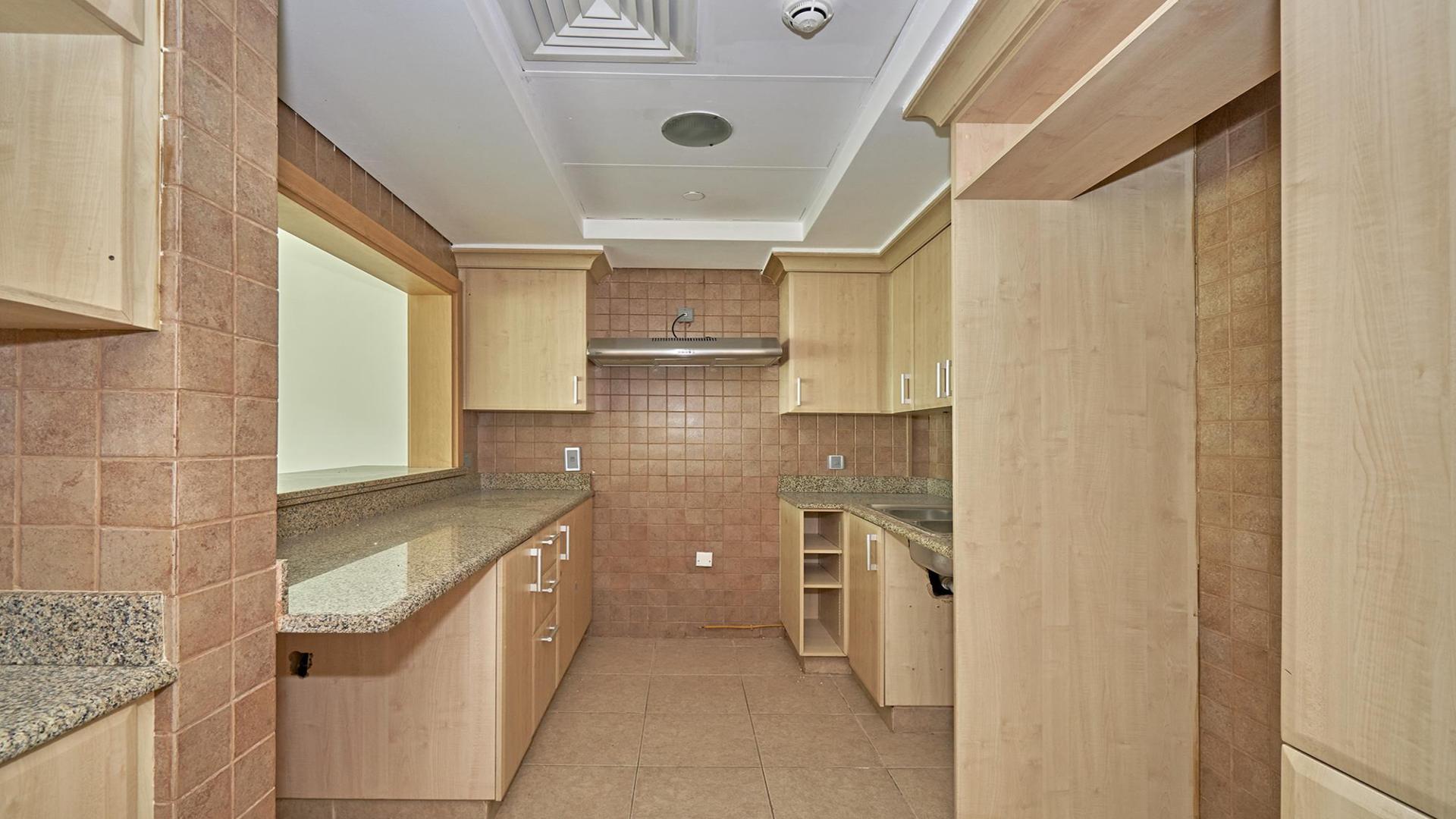 Empty living room in Palm Jumeirah Shoreline Apartment with large windows and balcony view