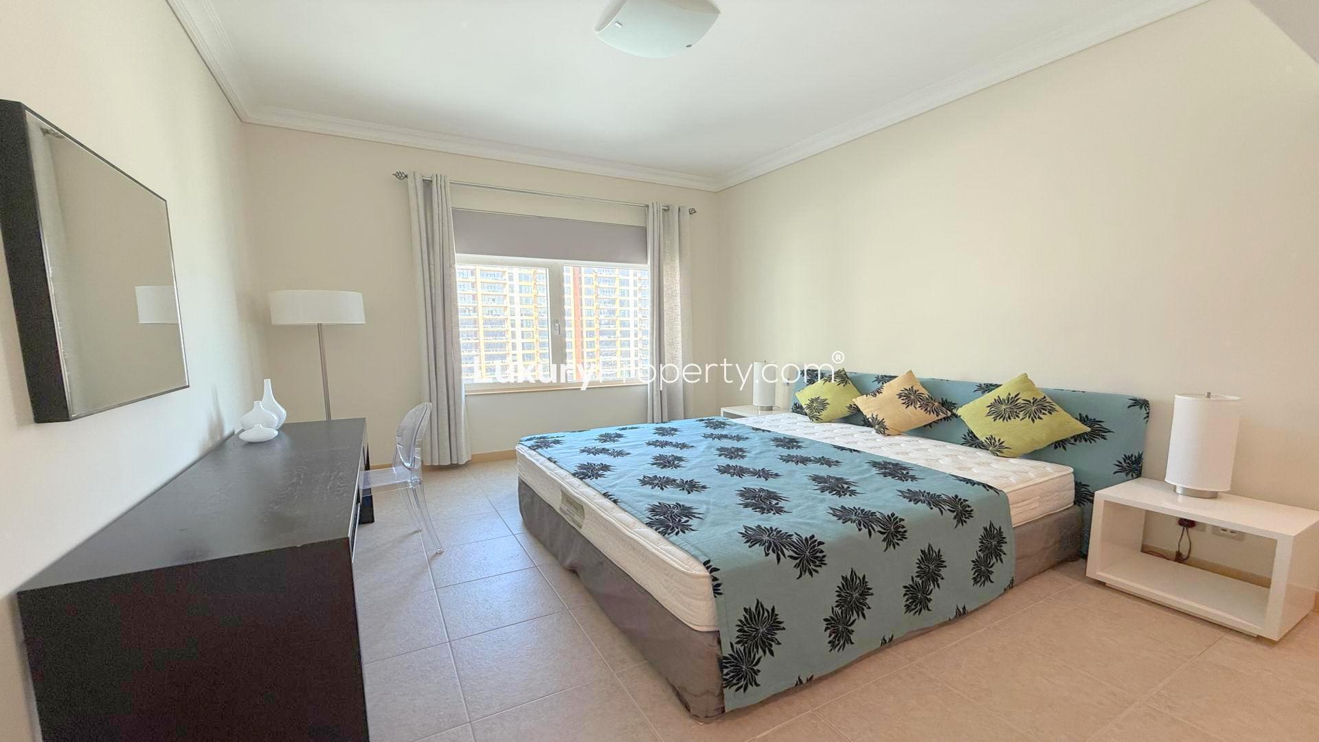 Furnished balcony view at Al Das Shoreline Apartments, Palm Jumeirah, with sea and building scenery