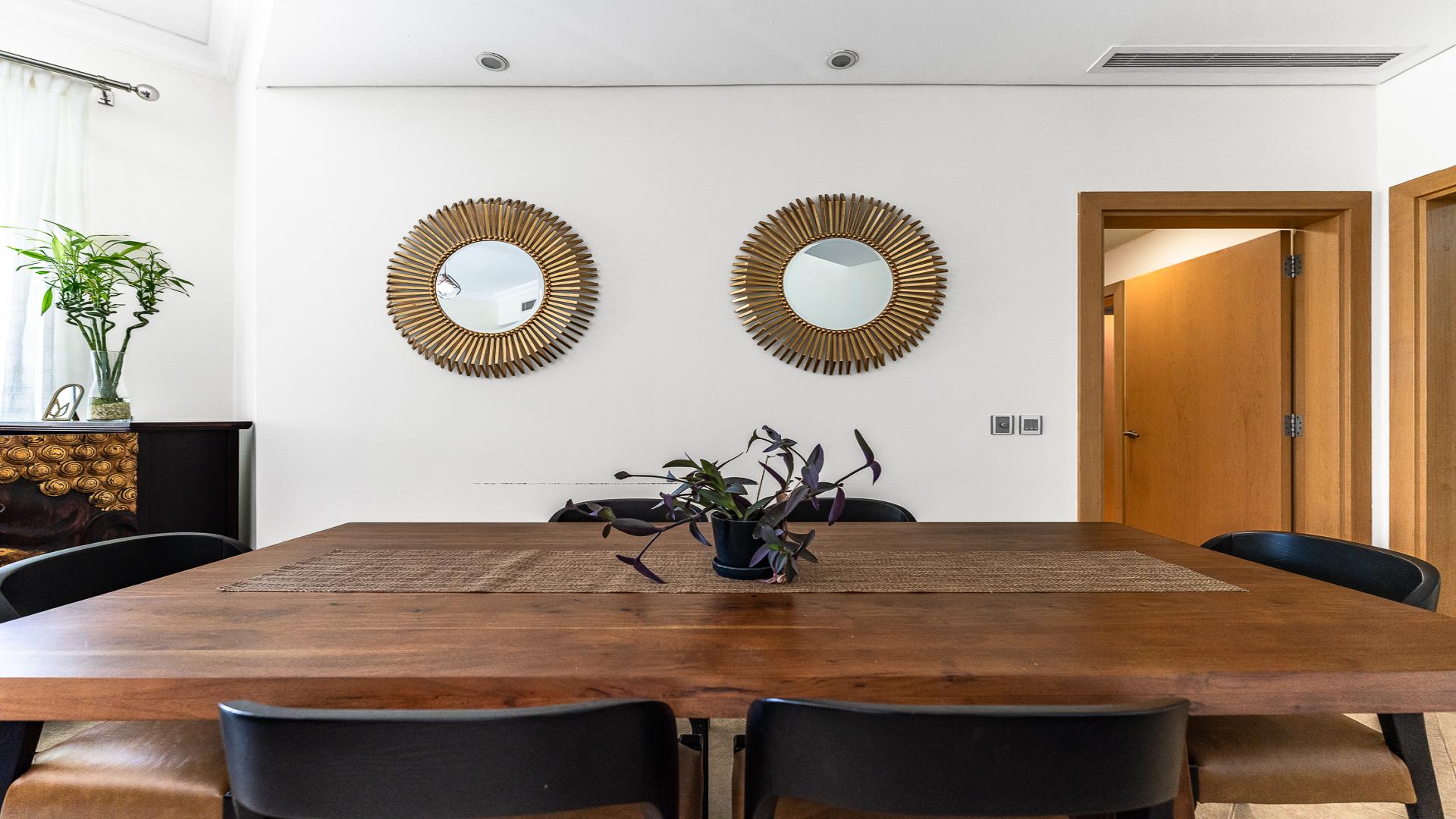 Luxurious living room in Shoreline Apartments, Palm Jumeirah, with modern furnishings and large windows